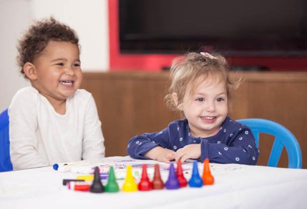 两个小女孩在纸上画画。图片下载