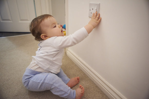 蹒跚学步的孩子玩插头插座图片下载