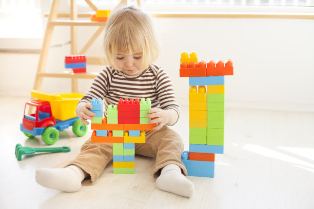 小孩子在玩五颜六色的塑料积木图片下载
