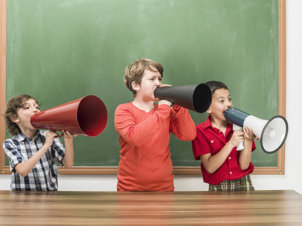 三个小男孩在黑板前用扩音器大喊大叫图片下载