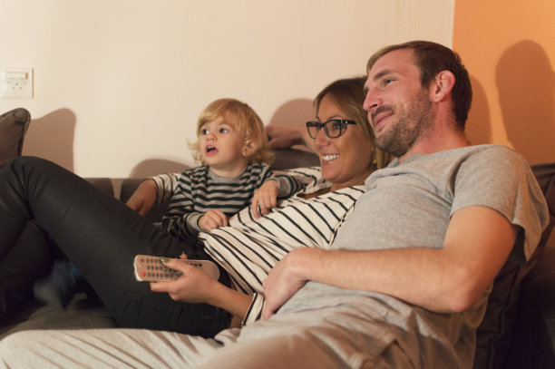 一家人坐在沙发上一起看电视图片下载