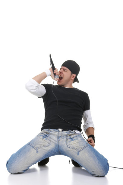 男歌手对着麦克风唱歌，背景是白色图片下载