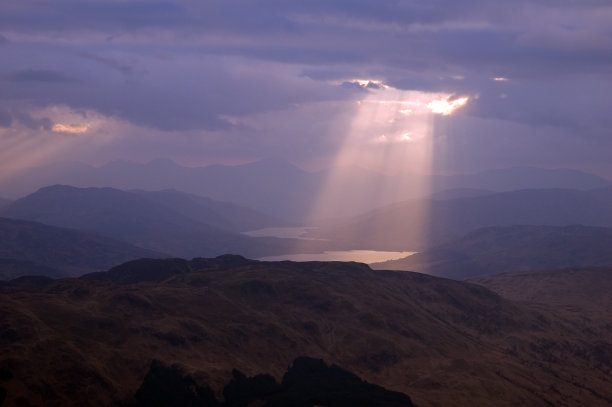 一束穿透灰色云层的阳光素材图片