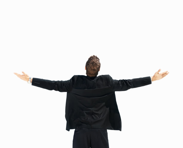 一个张开双臂的年轻商人的后视图图片下载