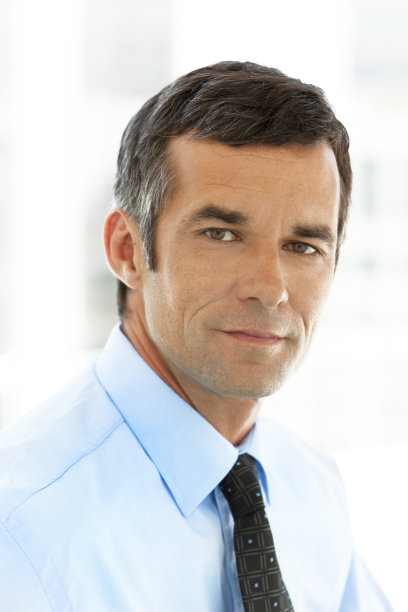 一个穿着蓝色衬衫打着蓝色领带的成熟商人的肖像图片下载