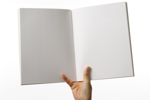 在白色背景下拿着一本打开的空白杂志图片下载