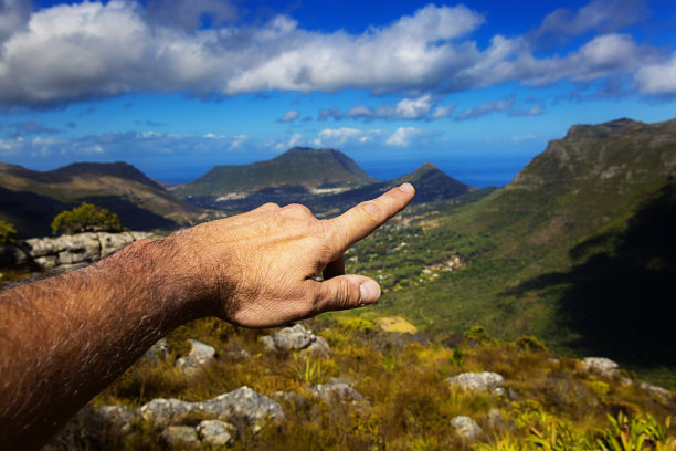 男人用手指着山峰图片下载