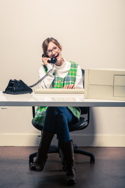 女商人在办公桌前打电话图片下载