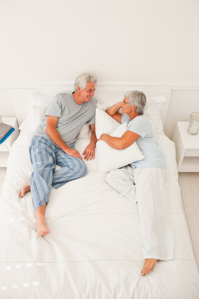 俯视图，一个快乐的老夫妇躺在床上图片下载