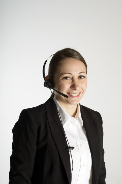 年轻女性呼叫中心员工戴着耳机，白色背景图片下载