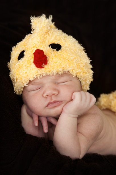 刚出生的女婴穿着一件黄色的小鸡装图片下载