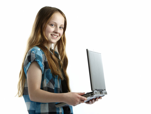 快乐微笑的女孩拿着银色的笔记本电脑图片下载