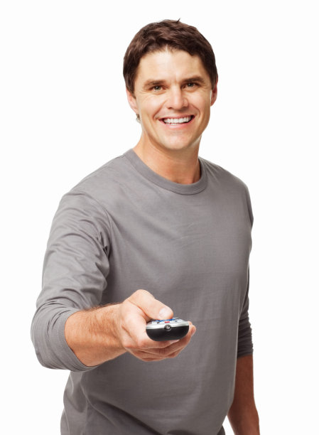 英俊的男人拿着遥控器-孤立的图片下载