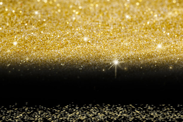 黑色背景上的金色闪光。图片下载