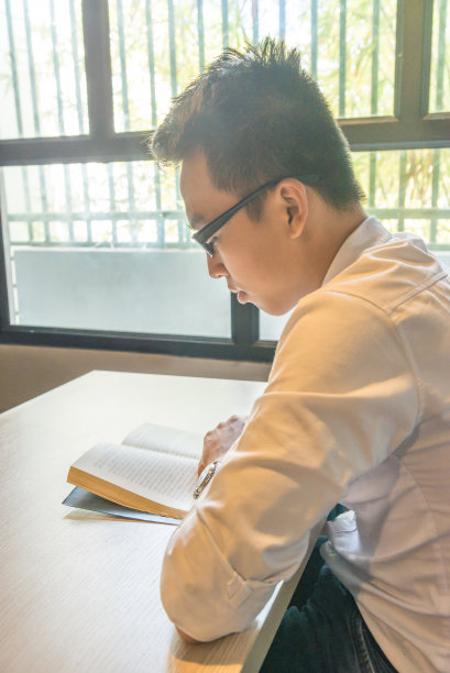 亚洲年轻人在白衬衫读书图片下载