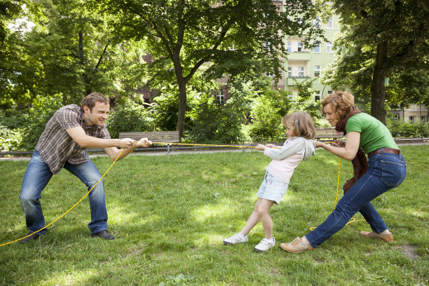 年轻的家庭有一起拉绳子的乐趣图片下载