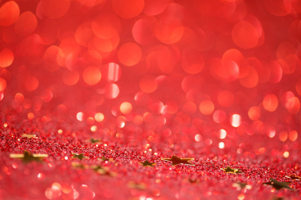 金色的星星在红色闪闪发光图片下载