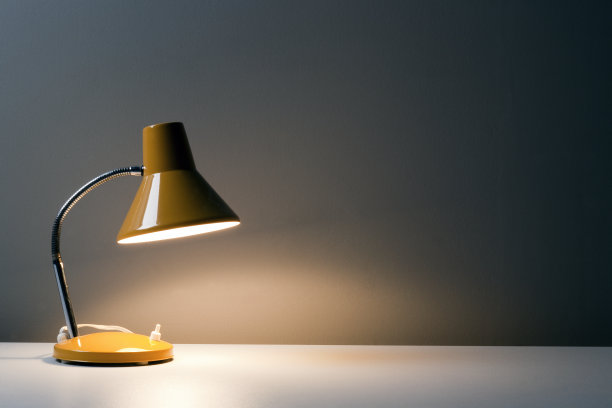 黄色的台灯照在白色的桌子上图片下载