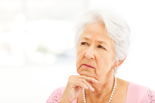 沉思的老女人手放在下巴看向别处图片下载