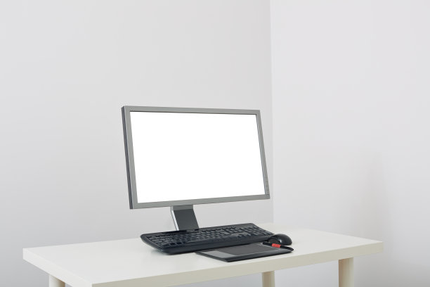 电脑屏幕，键盘，鼠标和一个图形平板电脑在白色的桌子上图片下载
