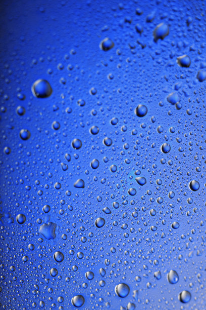 冰冰的玻璃杯新鲜的鸡尾酒覆盖着水滴凝结冷饮水滴蓝色的背景雨点纹理近距离图片下载