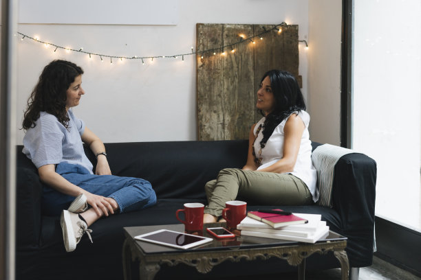 两个朋友坐在沙发上聊天图片下载