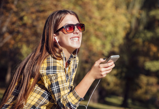 美丽的少女听着音乐微笑着图片下载