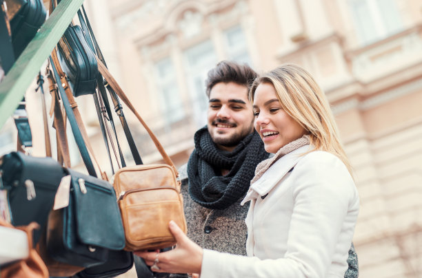年轻的情侣微笑着一起购物。约会，爱情，时尚，消费图片下载