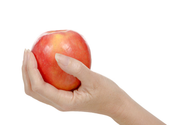 女人的手拿着红苹果。孤立在白色背景上。图片下载