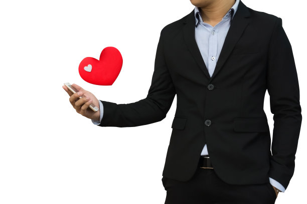 情人节概念商人看着他的心形图标的手机图片下载