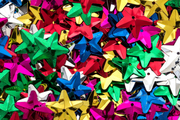 星星形状的彩色亮片作为节日派对的纹理背景图片下载