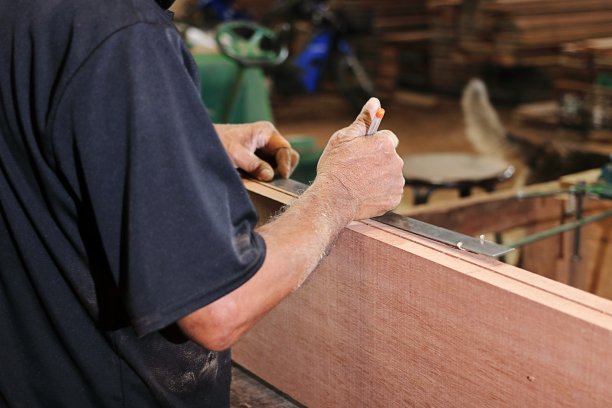 木工车间测量木板的高级木匠。选择性聚焦和浅景深。图片下载