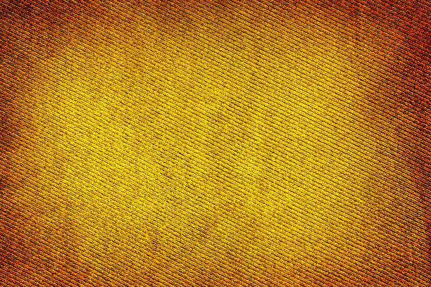金黄色的金织物编织纹理与高光晕效果的宏观背景形成鲜明对比图片下载