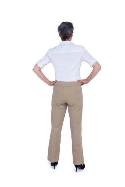 后视图的女商人与手在臀部图片下载