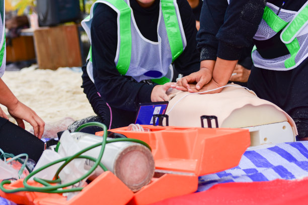 模拟在海滩上溺水的受害者进行心肺复苏训练图片下载