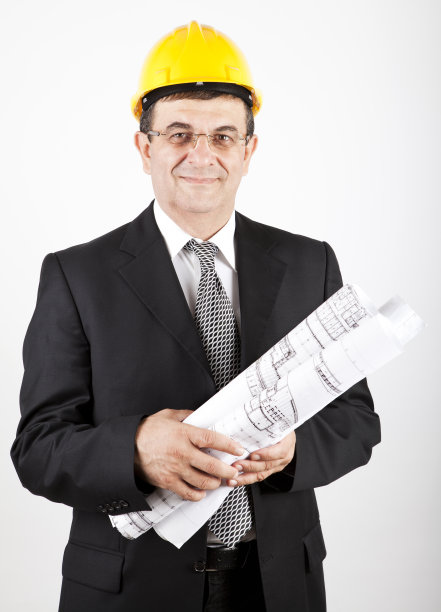 建筑师戴着蓝色安全帽，手持黄色印花的特写图片下载