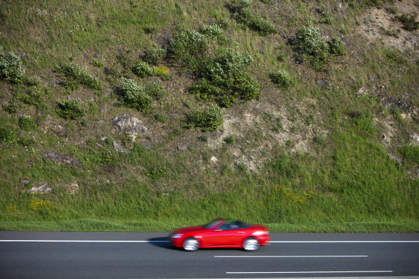 红色敞篷车在乡村公路上超速行驶图片下载