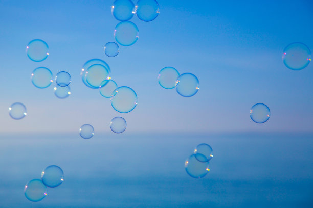 蓝色背景下漂浮在空中的抽象气泡图片下载