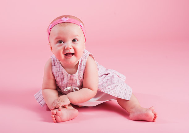 粉红色背景上快乐的小女孩的肖像图片下载