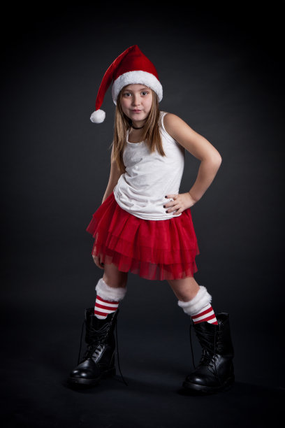 带着圣诞帽和大靴子的可爱小女孩。图片下载