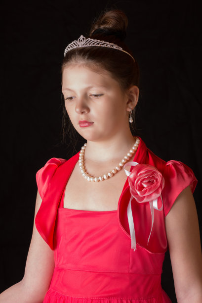 黑色背景下一个穿着裙子的女孩的肖像图片下载