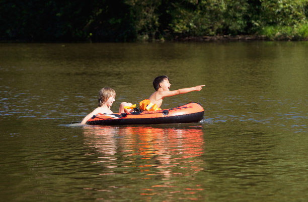 两个男孩在充气橡皮艇上玩图片下载