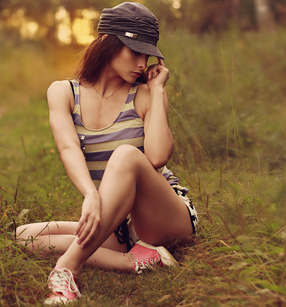 性感时尚的女人坐在草地户外背景图片下载