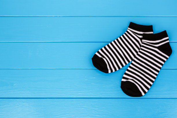一双袜子放在一个蓝色的木制背景上。图片下载