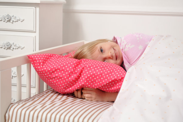 漂亮的小女孩睡在她的床上，然后醒来图片下载