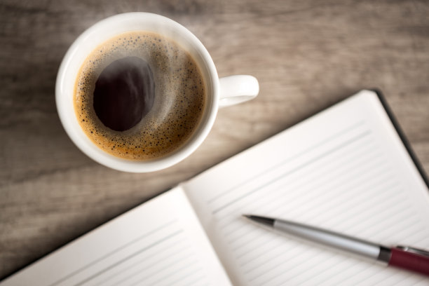 用咖啡杯打开空笔记本图片下载