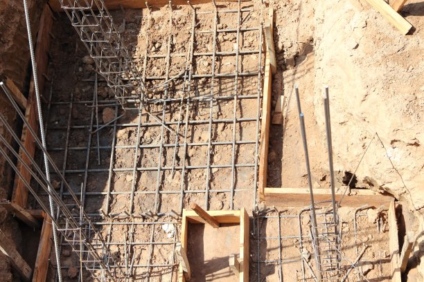 用铁丝把钢筋捆扎成柱子结构。图片下载