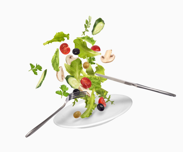 盘子里的沙拉落在白色的背景上图片下载