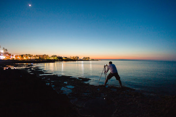 摄影师正在拍摄美丽的海景照片图片下载