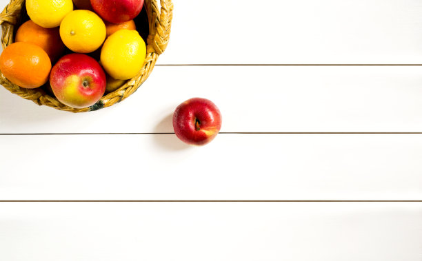 柳条篮子里的水果放在白色的木桌上图片下载